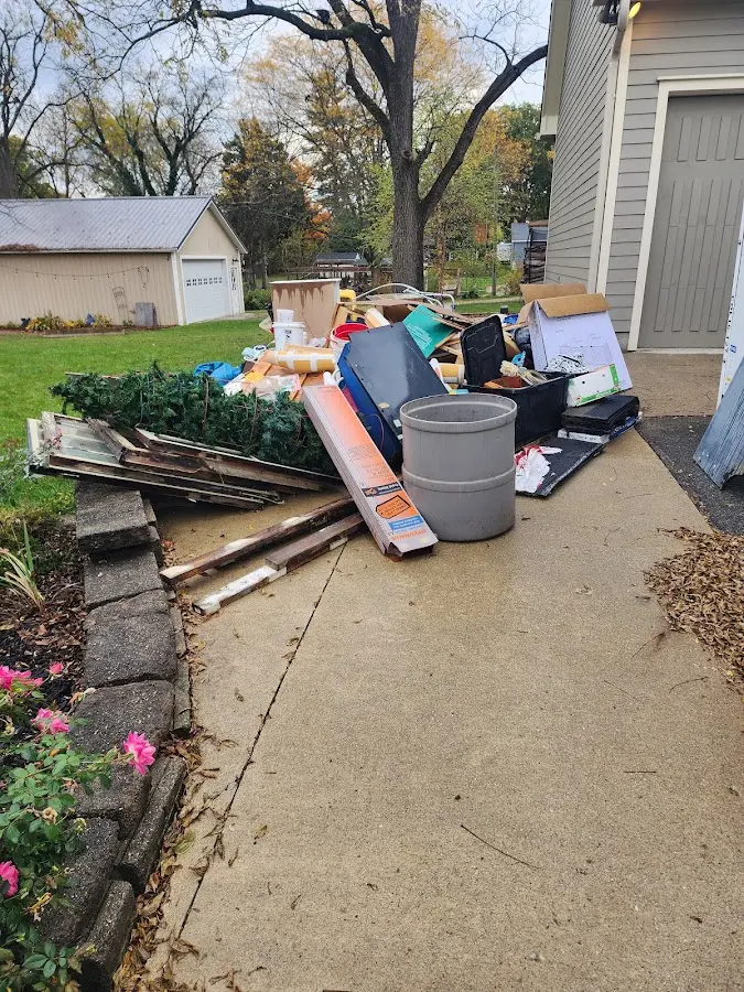 Dumpster being loaded with debris for Estate Cleanout Dumpster Rental in Olive